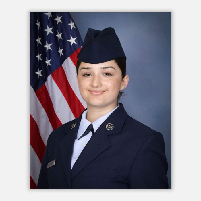 A portrait of an Airman in uniform, with the American Flag in the background.